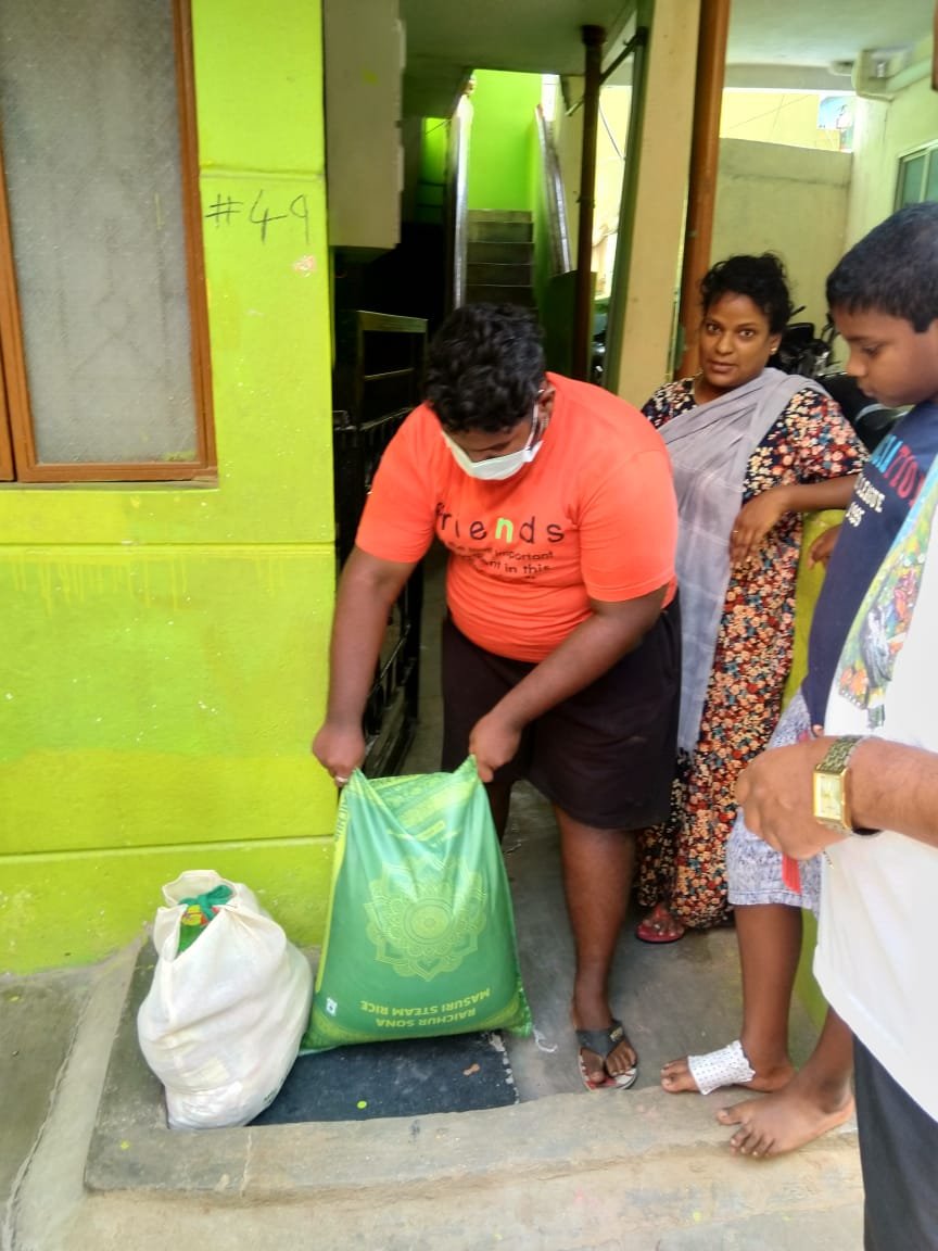 Slate volunteers handing out food supplies to families
