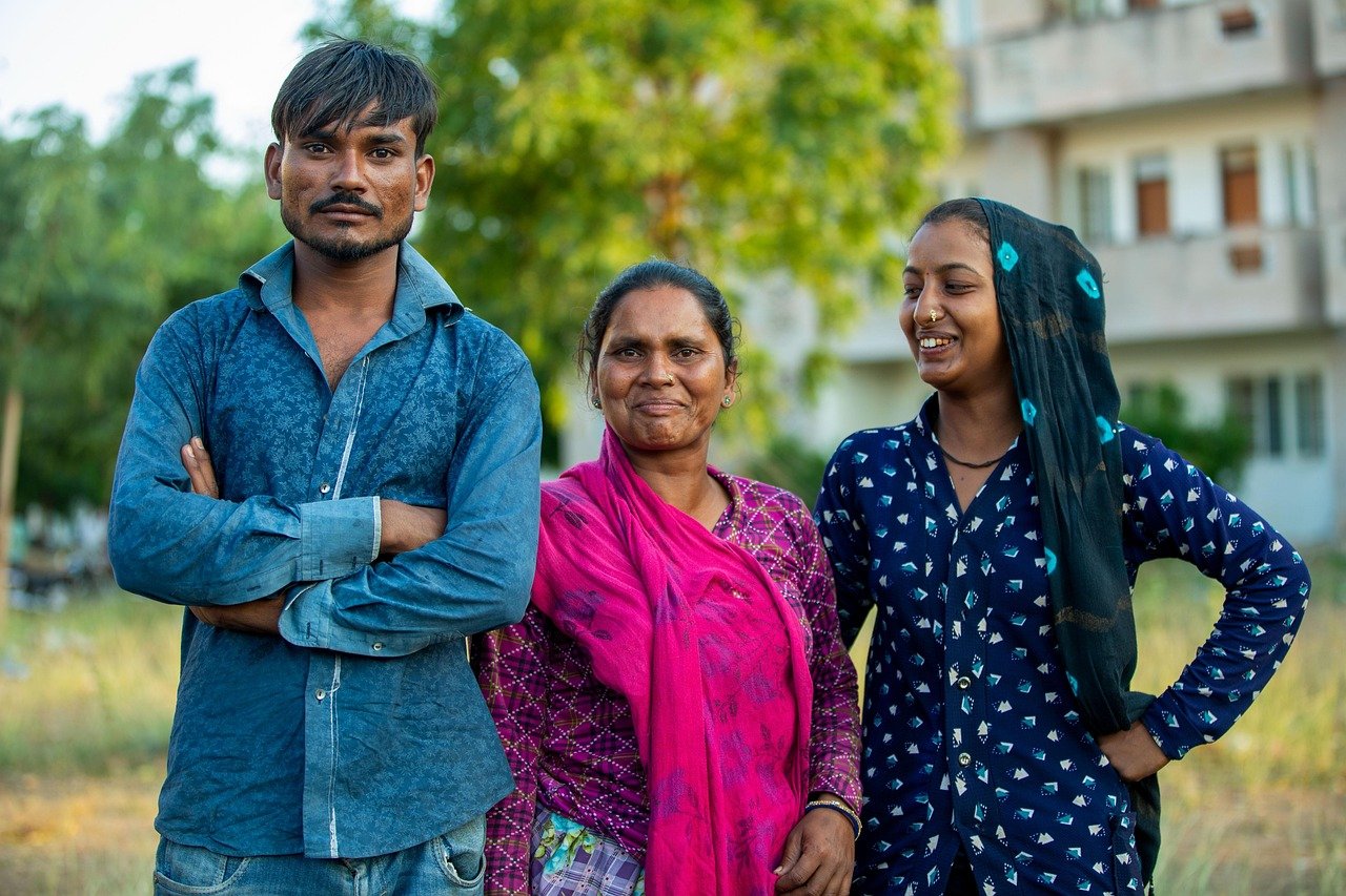 Three members of the community standing together outdoors